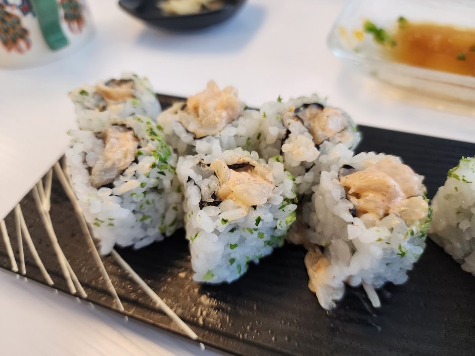 Fresh rolls beside soy sauce.